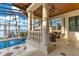 Covered upper balcony overlooking the pool, spa, and waterfront at 9243 Point Cypress Dr, Orlando, FL 32836