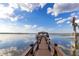 Picturesque lake view of a private dock featuring a covered structure at 9243 Point Cypress Dr, Orlando, FL 32836