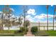 Pathway leads to a dock and seating area overlooking the lake, framed by lush landscaping and trees at 9243 Point Cypress Dr, Orlando, FL 32836