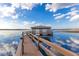 Picturesque dock extending into the lake, featuring a covered structure and scenic views at 9243 Point Cypress Dr, Orlando, FL 32836