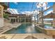 Relaxing in-ground screened pool and jacuzzi overlooking the open water at 9243 Point Cypress Dr, Orlando, FL 32836