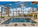 A beautiful screened-in pool with a waterfront view and a relaxing spa at 9243 Point Cypress Dr, Orlando, FL 32836