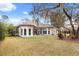 Rear view of the house showcasing the backyard, patio, and expansive windows at 9308 Thurloe Pl, Orlando, FL 32827