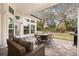 A covered patio with a table and chairs and a grill in the backyard at 9308 Thurloe Pl, Orlando, FL 32827