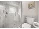 Marble tiled bathroom featuring glass shower, tiled floors and toilet at 9308 Thurloe Pl, Orlando, FL 32827