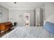 Bedroom features wood floors, a closet, and a white bed with a grey quilt at 9308 Thurloe Pl, Orlando, FL 32827