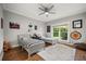 Bedroom with wood floors, two twin beds, a ceiling fan and a large window at 9308 Thurloe Pl, Orlando, FL 32827