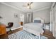 Bedroom features wood floors, a ceiling fan, and a white bed with a grey quilt at 9308 Thurloe Pl, Orlando, FL 32827