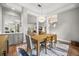 Bright dining room features hardwood floors, a modern chandelier, and access to the living room at 9308 Thurloe Pl, Orlando, FL 32827