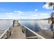 Picturesque view of a wooden dock extending into the serene waters of the lake at 9308 Thurloe Pl, Orlando, FL 32827