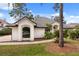 Beautiful home exterior featuring manicured lawn, lush landscaping, and a curved walkway at 9308 Thurloe Pl, Orlando, FL 32827