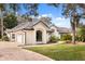 Beautiful home exterior featuring a well-manicured lawn, three car garage, and tile roof at 9308 Thurloe Pl, Orlando, FL 32827