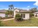 Beautiful home with a well-manicured lawn, lush landscaping, and arched entryways at 9308 Thurloe Pl, Orlando, FL 32827