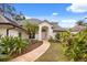 Charming home exterior with lush landscaping and a welcoming entryway, and tile roof at 9308 Thurloe Pl, Orlando, FL 32827