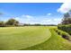 Expansive view of the meticulously maintained golf course with lush green grass and blue skies at 9308 Thurloe Pl, Orlando, FL 32827