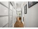 Hallway with wood floors and closet doors at 9308 Thurloe Pl, Orlando, FL 32827