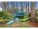 Assorted kayaks and paddleboards stored in a scenic, natural setting surrounded by trees and greenery at 9308 Thurloe Pl, Orlando, FL 32827