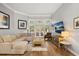 Inviting living room featuring wood floors, neutral tones, and a large sectional sofa at 9308 Thurloe Pl, Orlando, FL 32827