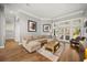 Bright living room with hardwood floors, crown molding, and neutral-toned sectional sofa at 9308 Thurloe Pl, Orlando, FL 32827