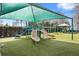 Fun playground featuring slides, climbing structures, and a soft, safe artificial turf surface at 9308 Thurloe Pl, Orlando, FL 32827