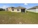 Spacious backyard with lush green lawn and exterior view of the house at 944 Brooklet Dr, Davenport, FL 33837