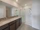 Bathroom featuring double sinks, granite countertop, and walk-in shower at 944 Brooklet Dr, Davenport, FL 33837