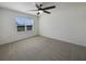 Cozy bedroom featuring a ceiling fan, soft carpet, and a large window providing natural light at 944 Brooklet Dr, Davenport, FL 33837