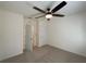 Carpeted bedroom with ceiling fan and closet at 944 Brooklet Dr, Davenport, FL 33837