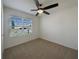 Bedroom with a ceiling fan and view of neighborhood through window at 944 Brooklet Dr, Davenport, FL 33837