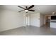 Bright, open living space with neutral tile flooring, an archway, and a modern ceiling fan at 944 Brooklet Dr, Davenport, FL 33837