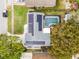 Aerial view of home with a beautiful in-ground pool, solar panels, and driveway at 9729 Heatherwood Ct, Orlando, FL 32825