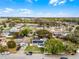 Aerial view of home with large tree, in-ground pool, and solar panels in a residential neighborhood at 9729 Heatherwood Ct, Orlando, FL 32825