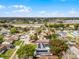 Aerial view of a home with solar panels, pool, large tree and mature landscaping at 9729 Heatherwood Ct, Orlando, FL 32825