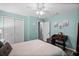 Well lit aqua bedroom with ceiling fan and double-door closet at 9729 Heatherwood Ct, Orlando, FL 32825