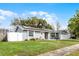 Charming single-story home with manicured lawn, solar panels and white fenced yard at 9729 Heatherwood Ct, Orlando, FL 32825