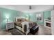 Bright main bedroom with mint walls, decorative fireplace, and a ceiling fan at 9729 Heatherwood Ct, Orlando, FL 32825