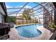 Sparkling private pool area, enclosed for enjoyment, next to a hot tub on a sunny day at 9729 Heatherwood Ct, Orlando, FL 32825