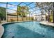 Beautiful in-ground pool within a screened enclosure, offering a perfect outdoor relaxation area at 9729 Heatherwood Ct, Orlando, FL 32825