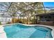 Inviting in-ground pool within a screened enclosure, surrounded by lush landscaping, and sun at 9729 Heatherwood Ct, Orlando, FL 32825