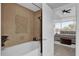 Spa-like bathroom featuring a soaking tub with tiled surround and modern fixtures at 101 S Eola Dr # 509, Orlando, FL 32801