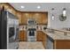 Updated kitchen with stainless steel appliances, granite counters, and wood cabinets at 101 S Eola Dr # 509, Orlando, FL 32801