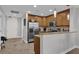 Well-lit kitchen featuring wooden cabinets and modern stainless steel appliances at 101 S Eola Dr # 509, Orlando, FL 32801
