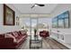 Bright living room with a view, sleek furnishings and a mounted television at 101 S Eola Dr # 509, Orlando, FL 32801