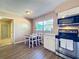 Bright kitchen with white cabinets, stainless steel appliances, and a cozy dining nook for enjoying meals at 1019 Camp Ave, Mount Dora, FL 32757