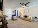 Inviting living room with a ceiling fan, beige colored walls and cozy furniture set against neutral carpeting at 1019 Camp Ave, Mount Dora, FL 32757