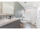 Bathroom featuring a white vanity, decorative backsplash, and a tub-shower combination with a window at 10339 Manila Bay Dr, Orlando, FL 32821