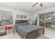 Bedroom boasts an outdoor view, a ceiling fan, light-colored flooring, and includes a workspace near the window at 10339 Manila Bay Dr, Orlando, FL 32821
