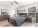 A cozy bedroom with wood floors, ceiling fan, a large window, and a full set of matching furniture at 10339 Manila Bay Dr, Orlando, FL 32821