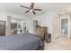 Bedroom showing light wood flooring, a ceiling fan, and a sliding glass door to the screened outdoor patio at 10339 Manila Bay Dr, Orlando, FL 32821