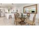Bright dining area adjacent to the kitchen with glass-top table and white cabinets at 10339 Manila Bay Dr, Orlando, FL 32821